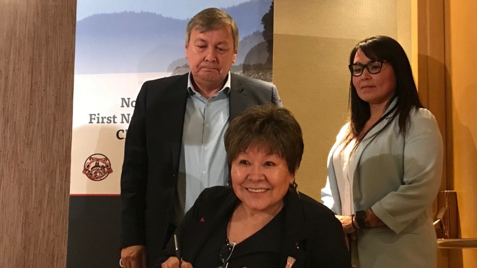 Eva Clayton, seated, president of the Nisga'a Lisims Government, John Helin, mayor of the Lax Kw;ala