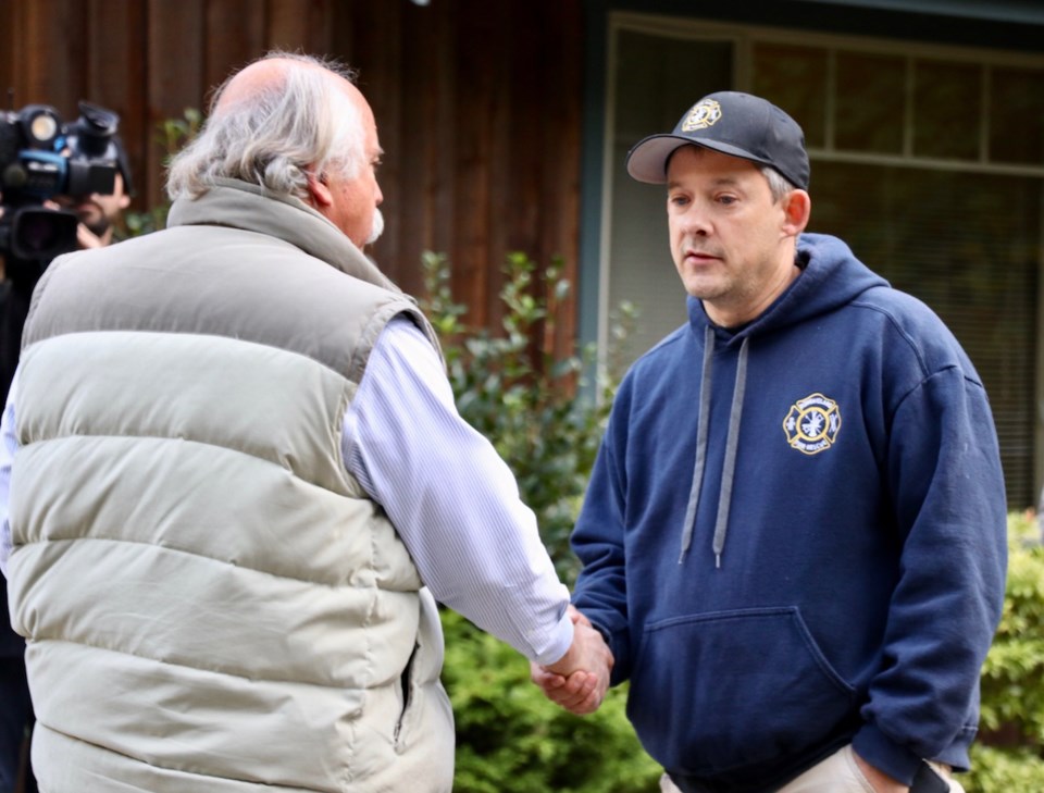 Mayor Gary Ander and spokesperson for the Bowen Island volunteer firefighters Mike Hartwick shake