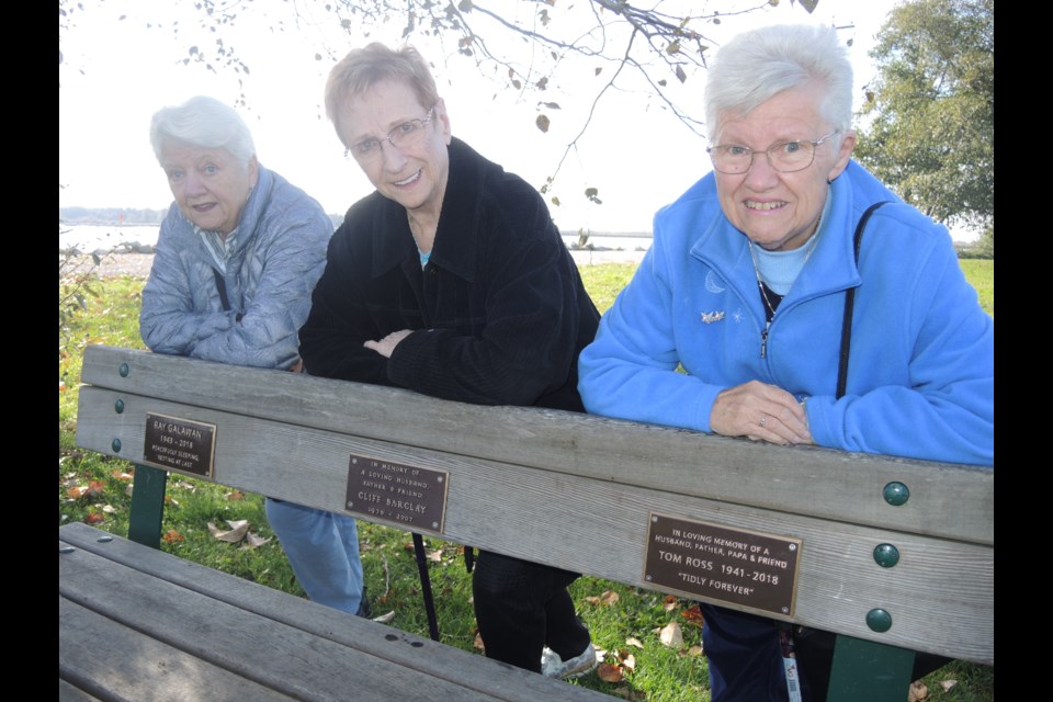 Lynne Barclay (centre) led the fight against city hall, along with Margaret Galawan (left) and Bonnie Ross, to have their late husbands, Cliff, Ray and Tom, respectively, remembered on the same park bench on the Finn Slough. Alan Campbell photos