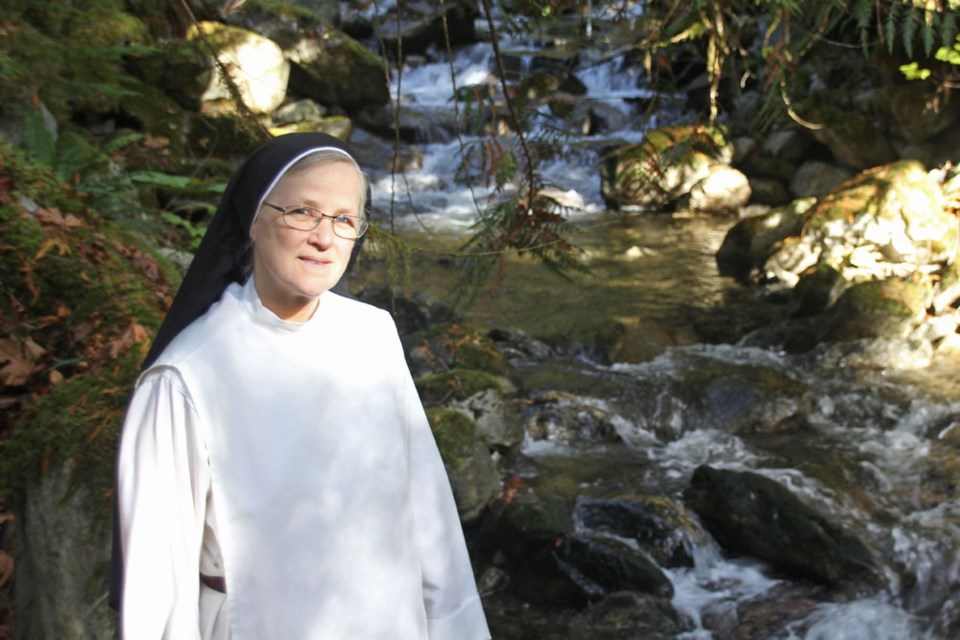 Sister Claire Rolf next to where the new turbine will be placed in the Pilchuck River for the Queen of Peace Monastery.