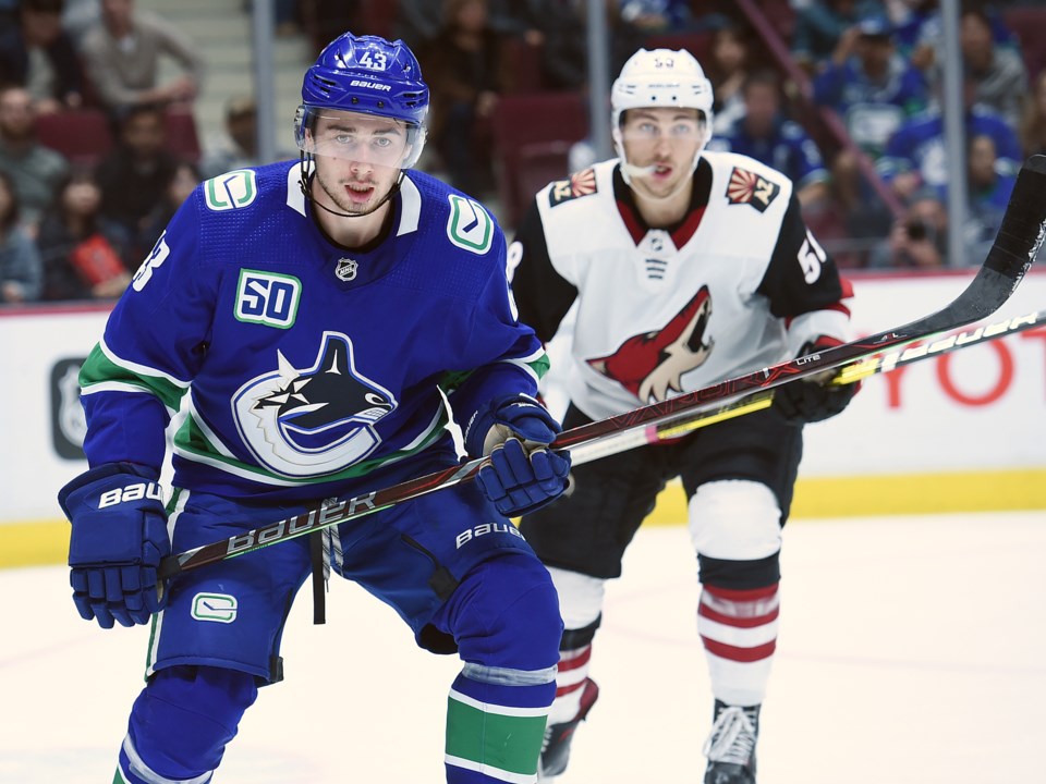 Quinn Hughes keeps an eye on the puck in the Canucks 2019 preseason.