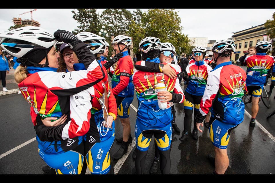 Cops for Cancer Tour De Rock riders embrace after arriving at journey&Otilde;s end at Centennial Square on Oct. 4.