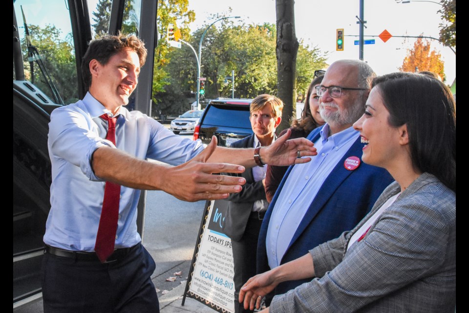 Trudeau greets Tri-City Liberal candidates Sara Badiei and Ron McKinnon as he arrives in downtown Port Coquitlam Friday, Oct. 11.