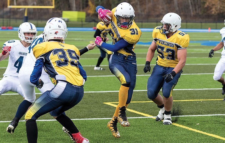 Nechako Valley Vikings player Bridger Jensen runs the ball against the College Heights Cougars on Friday afternoon at Masich Place Stadium. Citizen Photo by James Doyle