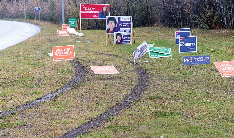 Vehicle tire tracks lead to damaged election signs on the green space at the entrance to the UNBC Campus on Saturday morning. Citizen Photo by James Doyle