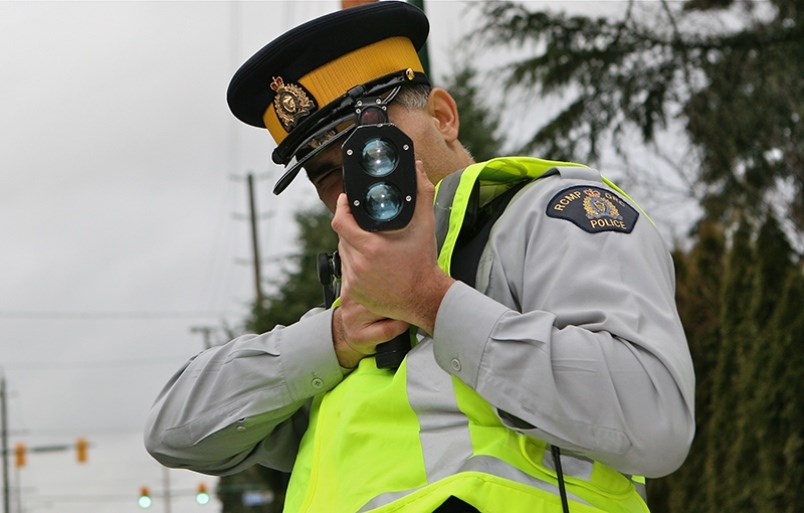 A Coquitlam RCMP officer uses a laser speed reader to detect speeds.