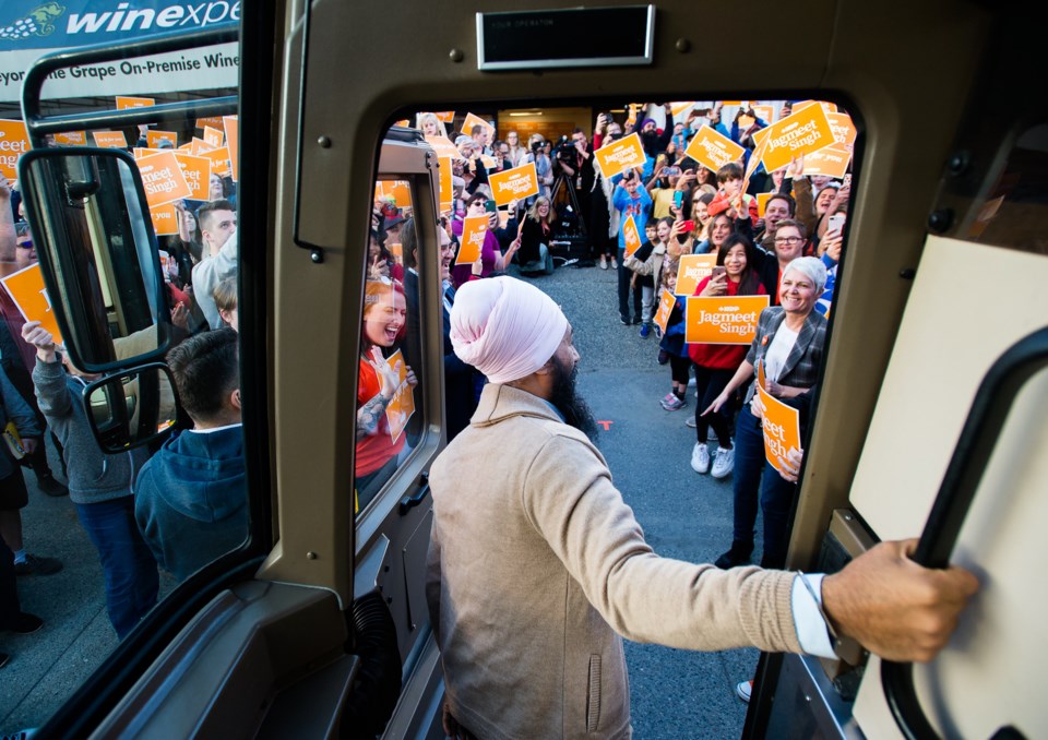 NDP leader Jagmeet Singh leaves his campaign bus before speaking at a rally during a campaign stop i