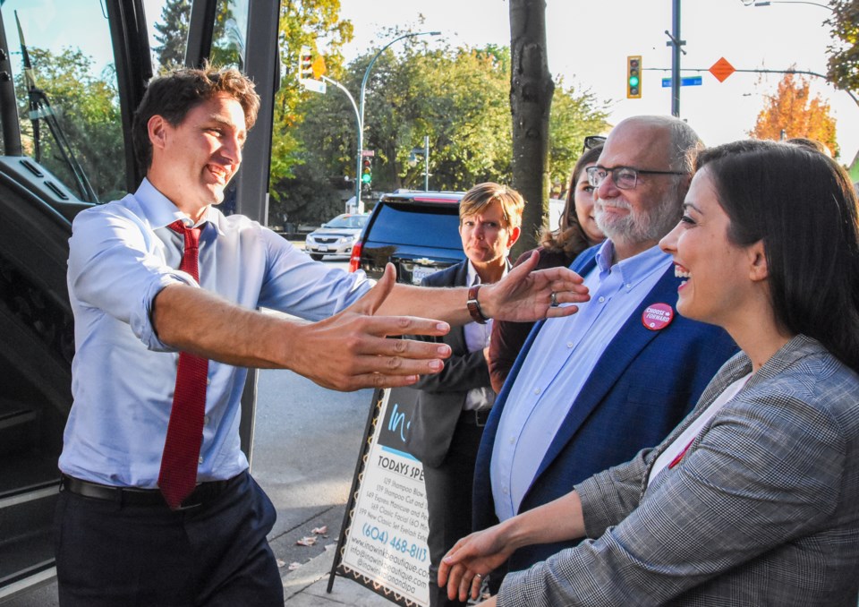 Trudeau greets Tri-City Liberal candidates Sara Badiei and Ron McKinnon as he arrives in downtown Po
