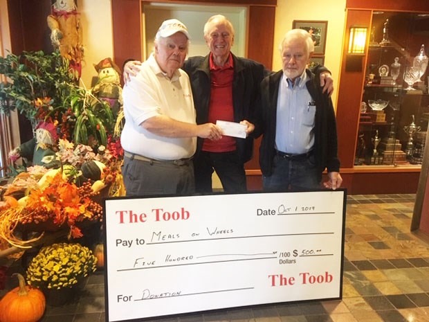 Tsawwassen Order of Old Bastards (TOOB) member Bob Tate presents a $500 cheque to thankful Delta Meals on Wheels volunteers Maurice Newby and Henry Neufeld.