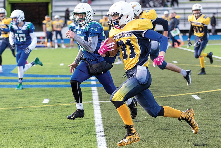 Nechako Valley Vikings player Bridger Jensen runs the ball against the Kelly Road Roadrunners on Friday afternoon at Masich Place. Citizen Photo by James Doyle