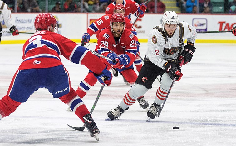 Prince George Cougars defenceman Cole Moberg skates the puck into the offensive zone against a pair of Spokane Chiefs defenders during an October 2019 game at CN Centre. With the Cougars still waiting for the start of training camp after Christmas, the 20-year-old from North Vancouver will be on loan to the Prince George Spruce Kings of the BCHL.