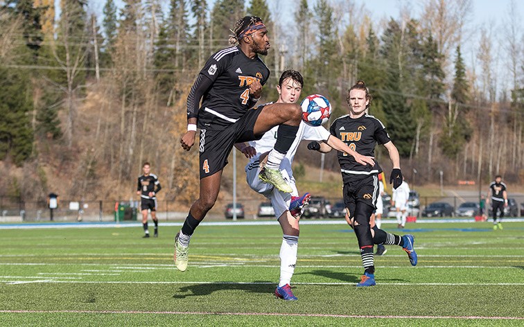 UNBC Timberwolves midfielder Owen Stewart and Thompson Rivers University WolfPack defender Josh Banton battle for the loose ball on Saturday afternoon at Masich Place Stadium. Citizen Photo by James Doyle