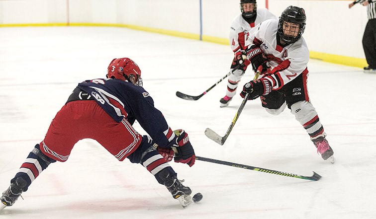 Cariboo Major Bantam Cougars player Anthony Duhamel tries to put a shot on goal against Greater Vancouver Major Bantam Canadians defender Ryan Keiji Nimi on Saturday afternoon at Kin 2. Citizen Photo by James Doyle