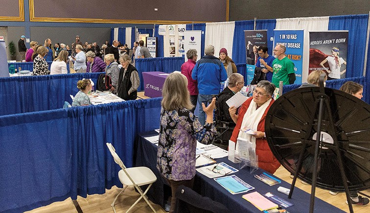 Guests discuss health and wellness with vendors at the Healthier You Expo on Sunday at Prince George Civic Centre. Citizen Photo by James Doyle