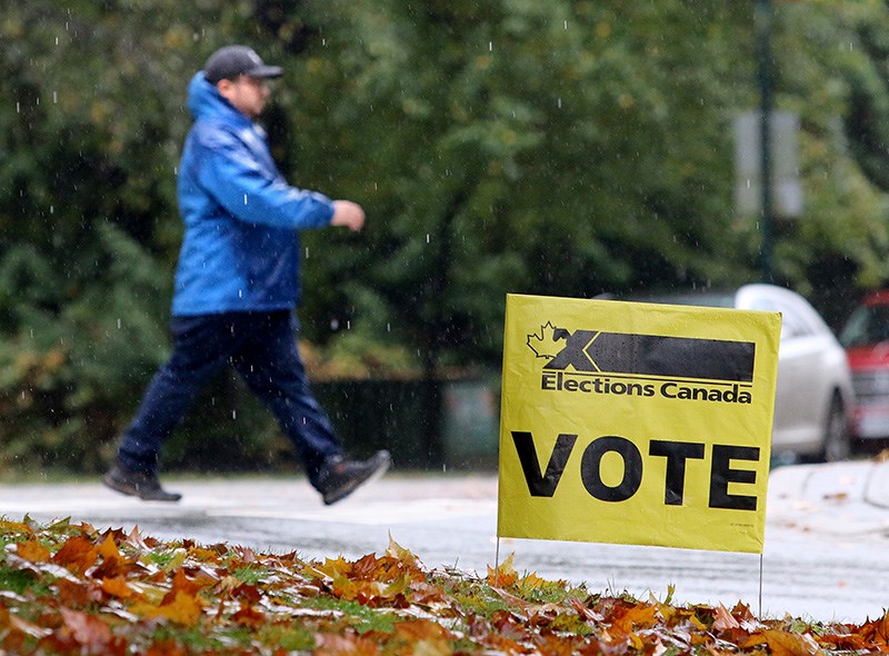 Voters heading to the polls in Monday's federal election brave heavy rain and cold temperatures.