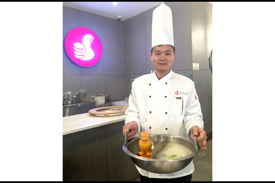 Chef Zheng presents their signature hot pot broth. Nono Shen photo
