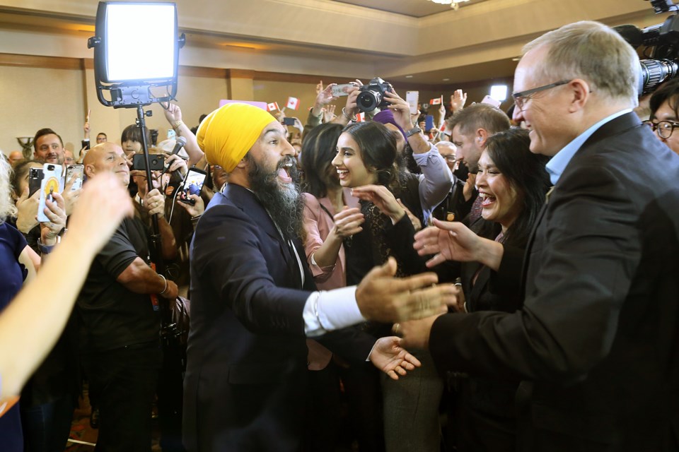 Jagmeet Singh greets successful NDP candidates Jenny Kwan and Peter Julian at the NDP celebration election night.