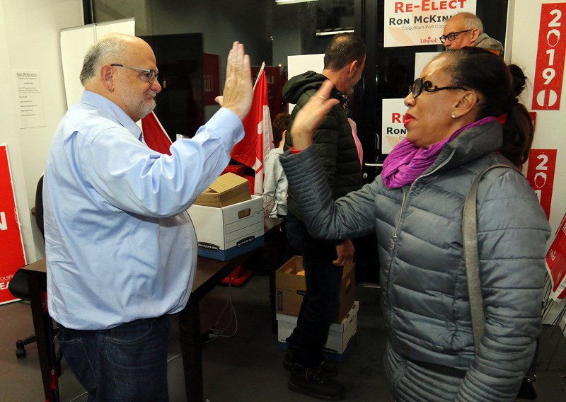 The re-elected Liberal MP for Coquitlam-Port Coquitlam, Ron McKinnon, gets a congratulatory high-five from a volunteer at his campaign headquarters in downtown Port Coquitlam on Monday.