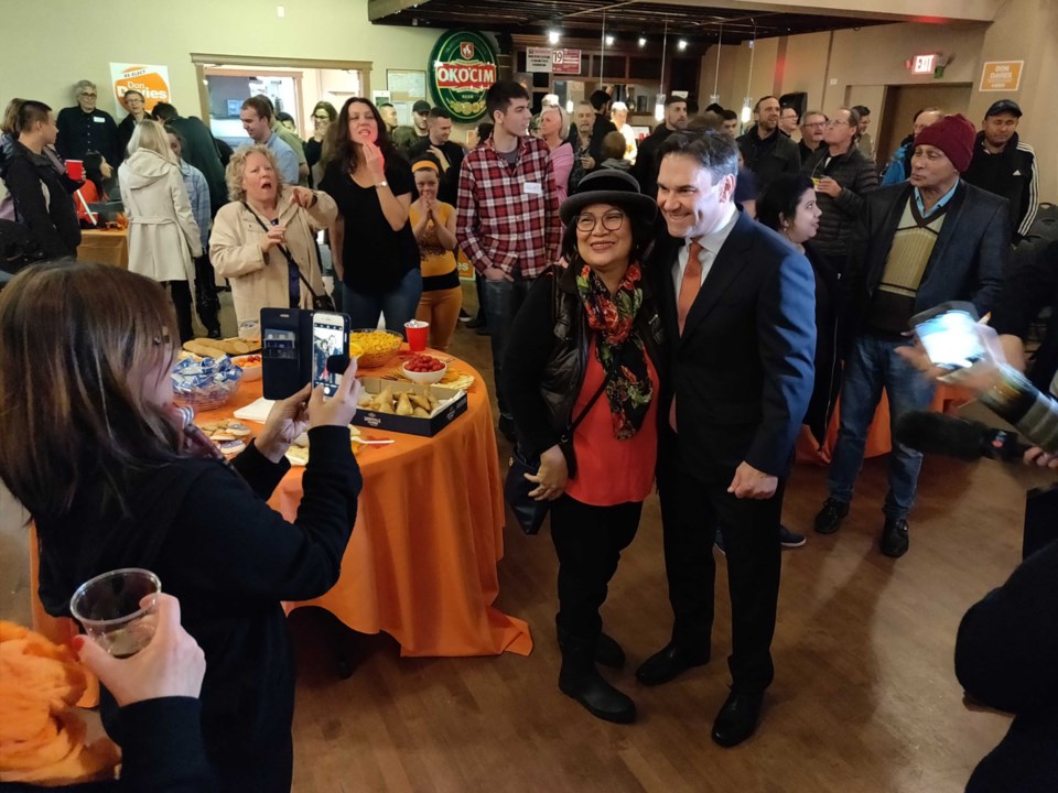 Vancouver Kingsway NDP incumbent Don Davies poses for pictures with supporters at his victory party.