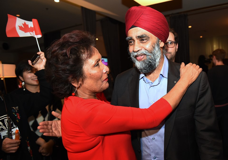 Vancouver Centre MP Hedy Fry gives Vancouver South MP Harjit Sajjan a hug after both Liberal incumbe