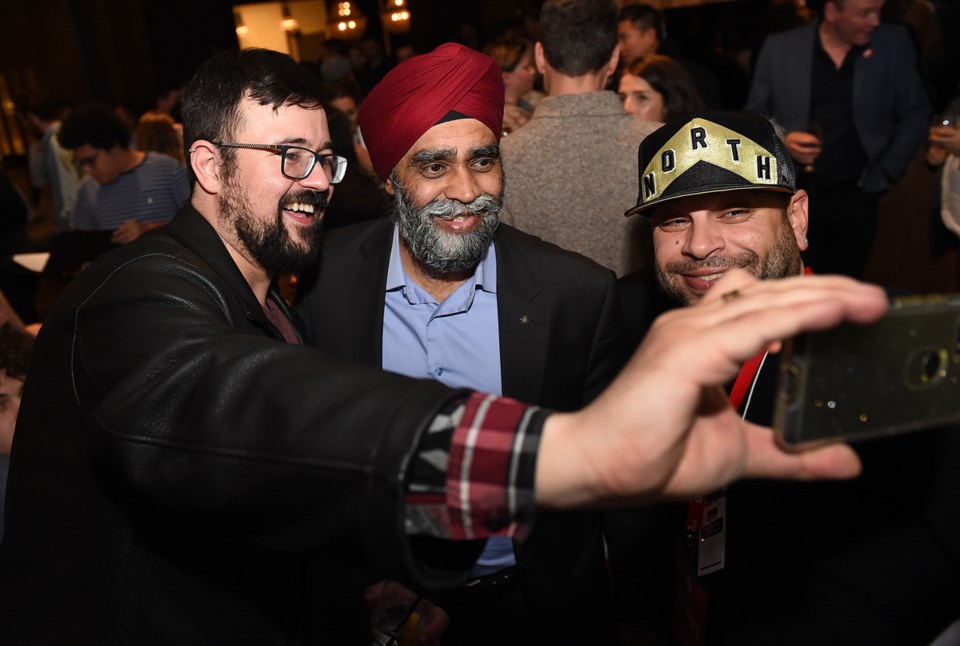 Vancouver South Liberal MP Harjit Sajjan takes a selfie with his supporters after his re-election vi