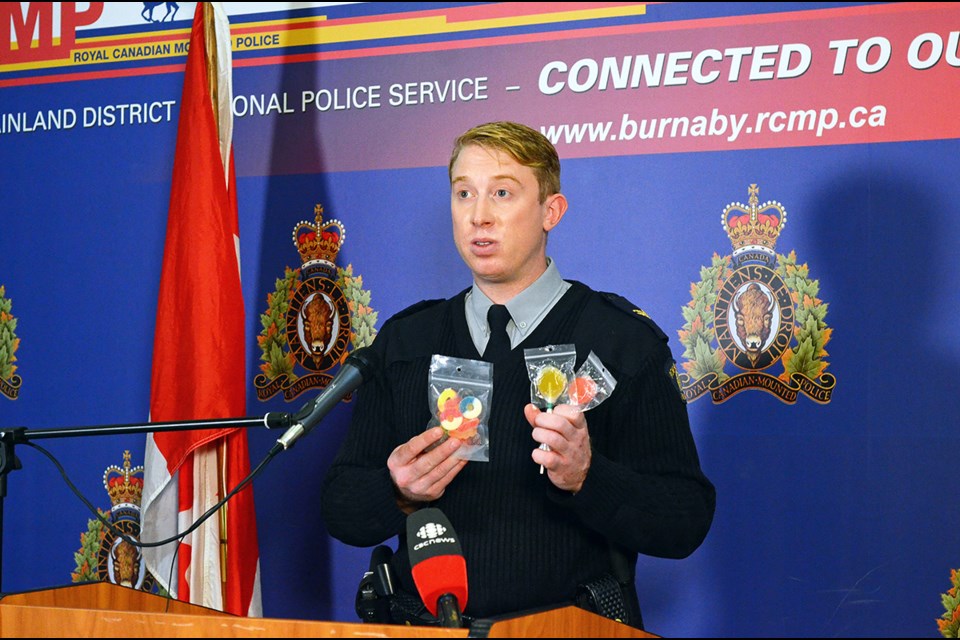 Burnaby RCMP Cpl. Brett Cunningham holds up some cannabis infused candy seized from an illegal dispensary in Metrotown this summer.