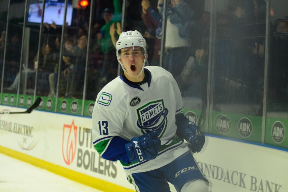 Kole Lind celebrates a goal for the Utica Comets.