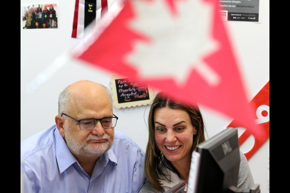 The Liberal MP for Coquitlam-Port Coquitlam, Ron McKinnon, watches election night results come in with one of his campaign volunteers, Haley Hodgson