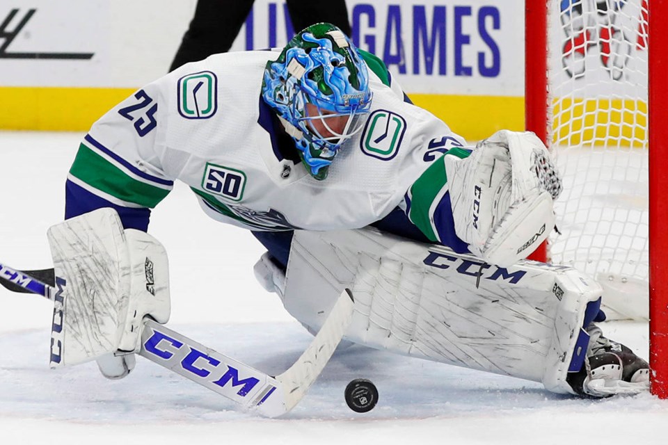 The Canucks' Jacob Markstrom makes a spectacular save against the Detroit Red Wings.