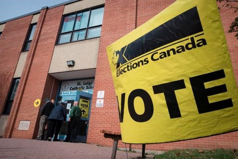 Voters enter the polling station at St. Luigi Catholic School during election day in Toronto on Mond
