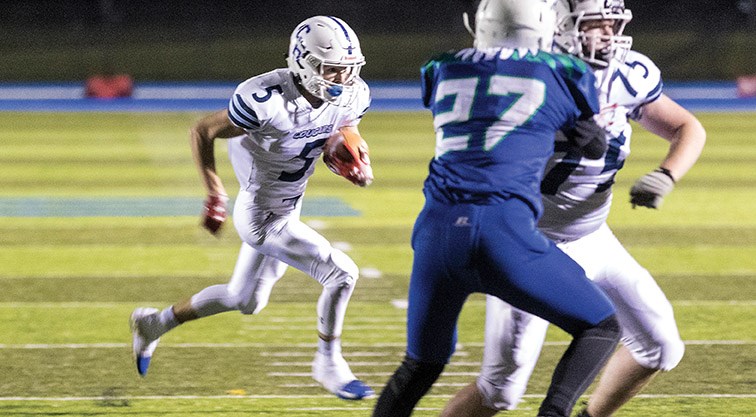 College Heights Cougars player Austin Adams runs the ball against the Kelly Road Roadrunners on Friday night in the one of the B.C. Secondary Schools Northern AA Conference semi-final match-ups. Citizen Photo by James Doyle