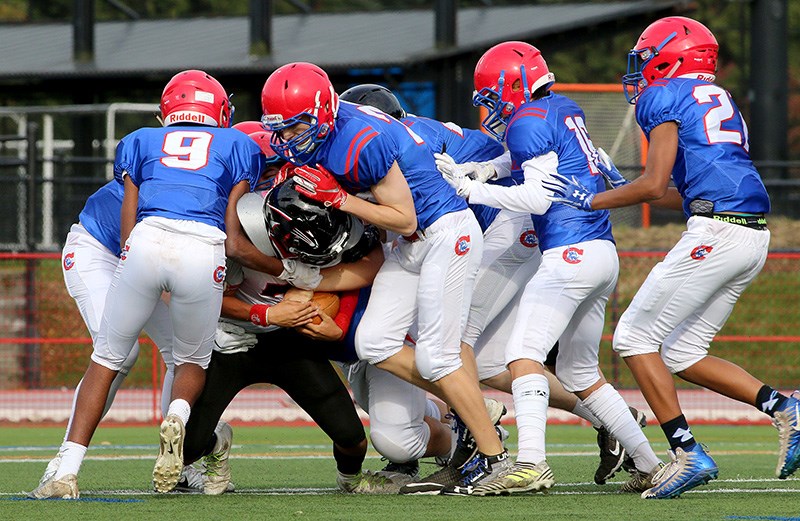 An Abbotsford Panthers ball carrier is tackled by a pack of Centennial Centaurs defenders in their BC Secondary Schools Football Association junior varsity game, last Wednesday at Percy Perry Stadium in Coquitlam. Centennial won, 42-8.