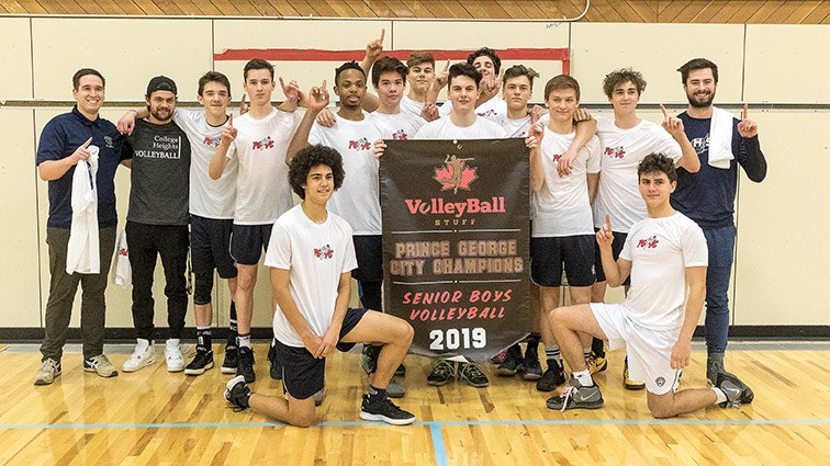The College Heights Cougars senior boys volleyball team pose with the banner they won as city champs after defeating the Duchess Park Condors on Wednesday night at College of New Caledonia gymnasium. Citizen Photo by James Doyle