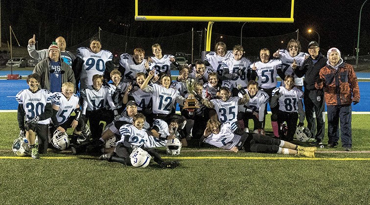 College Heights Cougars players and coaches pose for a team photo with the championship trophy after defeating the Duchess Park Condors on Wednesday evening at Masich Place Stadium to repeat as Northern Conference AA Junior Varsity champions. Citizen Photo by James Doyle