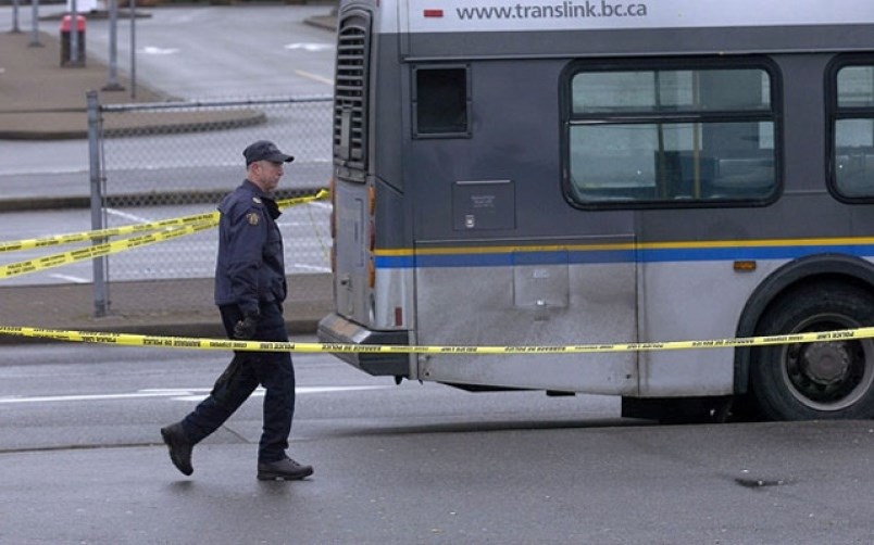 Investigators comb the Coquitlam Central Station bus loop after a stabbing incident early on Dec. 15, 2011.