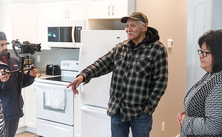 Lheidli T'enneh elder Peter John takes a look around the interior of his new home on Friday.