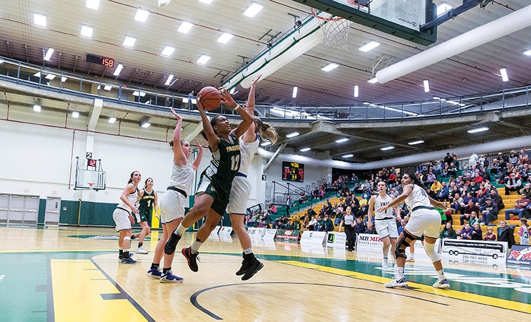 UNBC Timberwolves forward Maria Mongomo goes for a layup against a University of Victoria Vikes defender on Saturday night at Northern Sport Centre. Citizen Photo by James Doyle