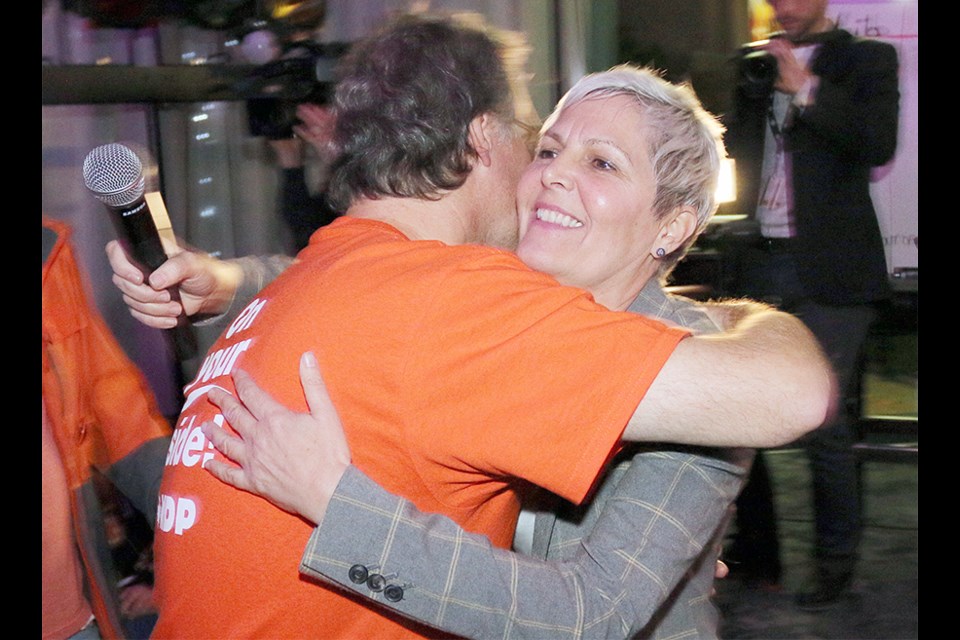 NDP candidate Bonita Zarrillo embraces outgoing MP Fin Donnelly on election night.