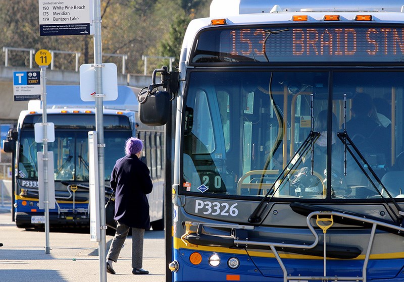 A passenger boards a bus in Coquitlam.