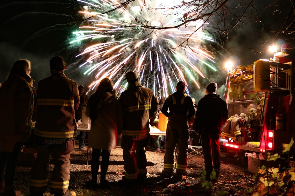 Hundreds of islanders watched the Bowen firefighters’ annual Deep Bay fireworks show Halloween evening. Due to concern for animals, this year’s show was shorter than usual but a hit nonetheless. In this photo firefighters wait to hand out hot chocolate after the display.
