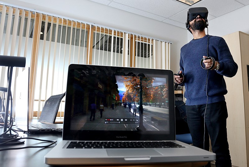 MARIO BARTEL/THE TRI-CITY NEWS Jeeven Bhambra, a digital engagement specialist with the Aspyr-Ibi Group, demonstrates a new virtual reality walk-through of plans for Coquitlam's Town Centre area. The city has contracted the service to engage the public on what the city's future could look like.