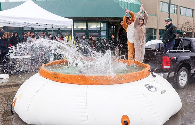 Students dressed in onesies make a big splash into a pool of ice water during the 11th annual UNBC JDC West Chillin’ for Charity on Friday afternoon in front of CN Centre. Citizen Photo by James Doyle
