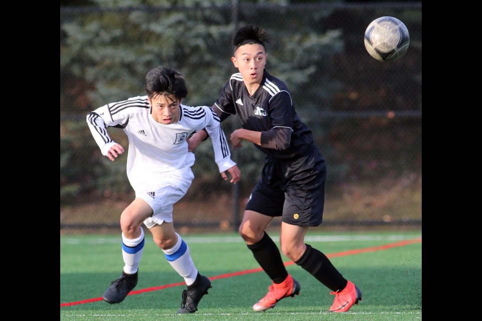 MARIO BARTEL/THE TRI-CITY NEWS
Michael Cho, of the Dr. Charles Best Blue Devils and Moscrop Panthers' Edison Phung keep their eye on the ball in the first half of their Fraser North Athletic Association AAA senior boys soccer district final, last Thursday at Coquitlam's Town Centre Park. Moscrop won, 4-1. Both teams advance to the provincial championships that will be played in Burnaby beginning Nov. 21.