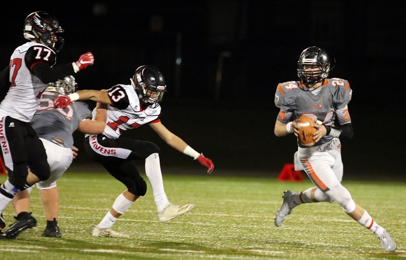 MARIO BARTEL/THE TRI-CITY NEWS
New Westminster Hyacks quarterback Andros Dancey scrambles away from the pursuit of a pair of Terry Fox Ravens defenders n the first half of their BC Secondary Schools Football Association wild card playoff game, Friday at Mercer Stadium in New Westminster. The Hyacks won, 45-6.