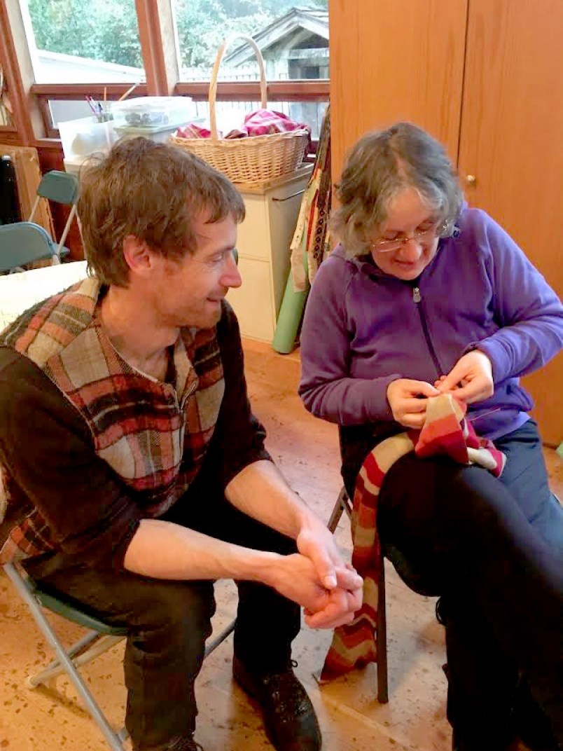 Shasta Martinuk mends a scarf for Carsten Crolow.