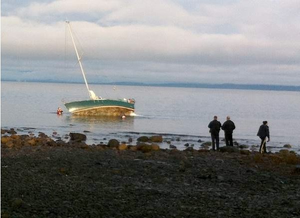 Police and search and rescue officials at beach where sailboat ran aground Monday afternoon