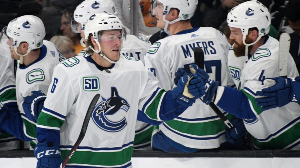 Brock Boeser celebrates a goal at the Canucks bench.