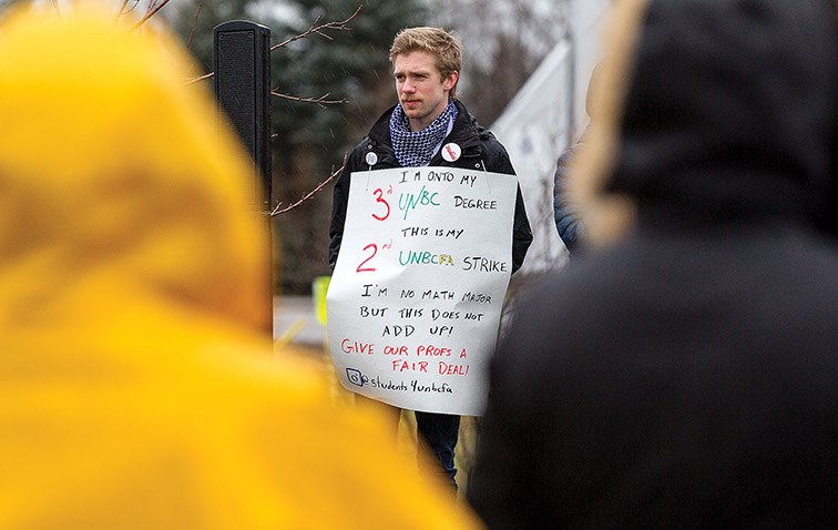 Students carry signs of support during a UNBC student rally in support of the UNBC Faculty Association on Saturday at Mr. P.G. Citizen Photo by James Doyle