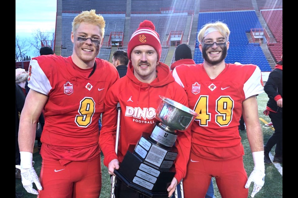 South Delta graduates (left to right) Grant McDonald, Jack McDonald and Jacob Kirk pose with the Mitchell Bowl after Calgary Dinos win over McMaster on Saturday at McMahon Stadium, sending them to the Vanier Cup next weekend in Quebec City.