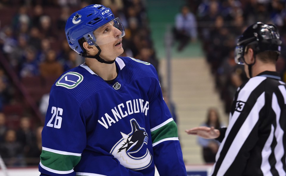 Antoine Roussel checks the scoreboard during a game for the Vancouver Canucks.